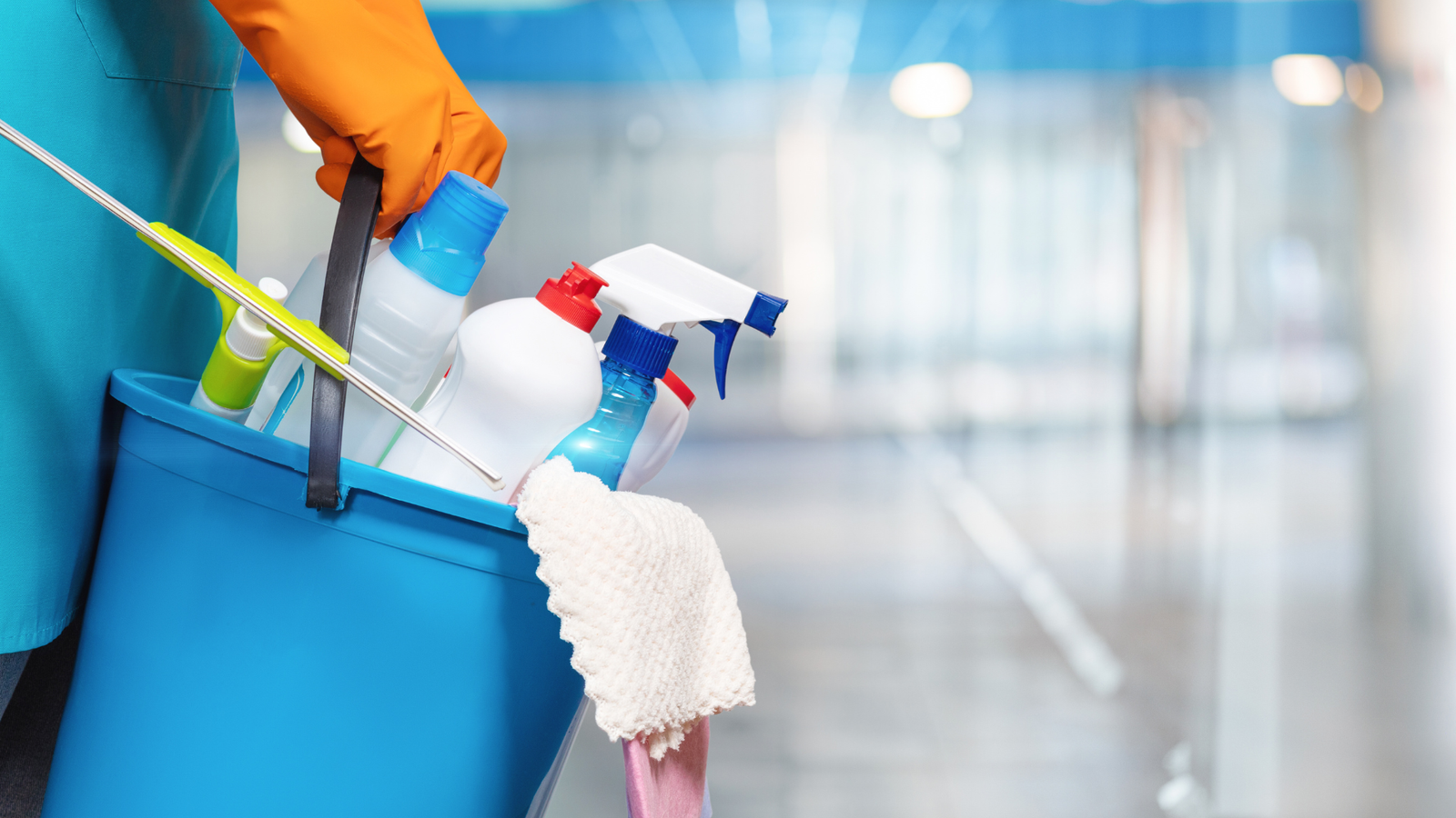 Professional cleaner holding a bucket and cleaning supplies, representing reliable cleaning services.